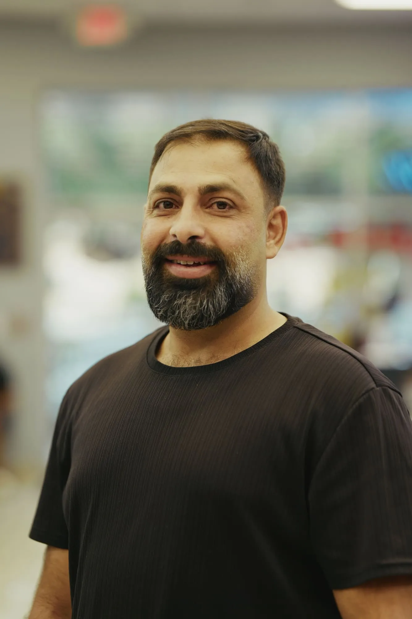 Indoor portrait of a bearded man wearing a black shirt