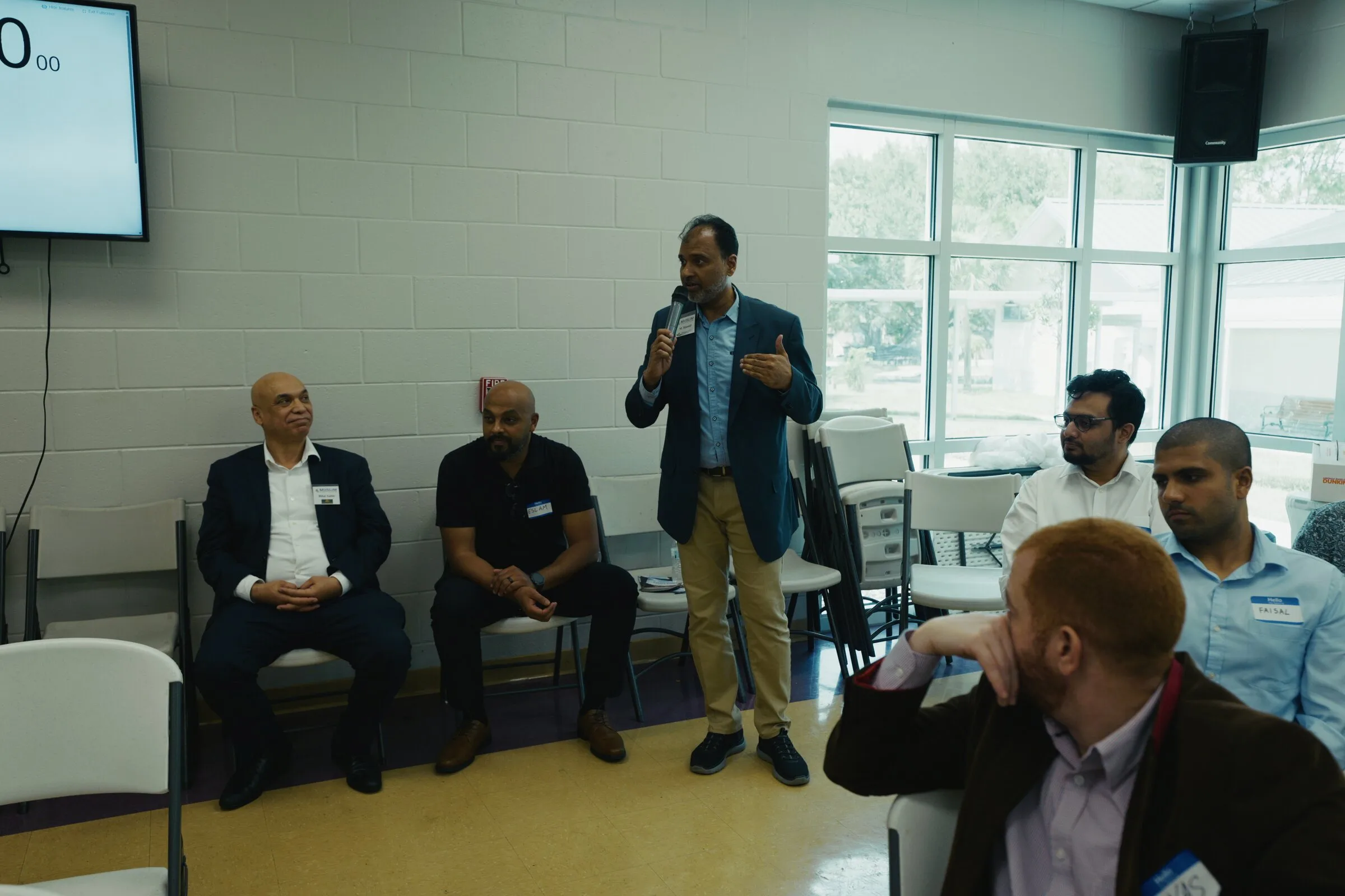 A presenter speaking to attendees during the Muslim Chamber of Commerce USA AI workshop