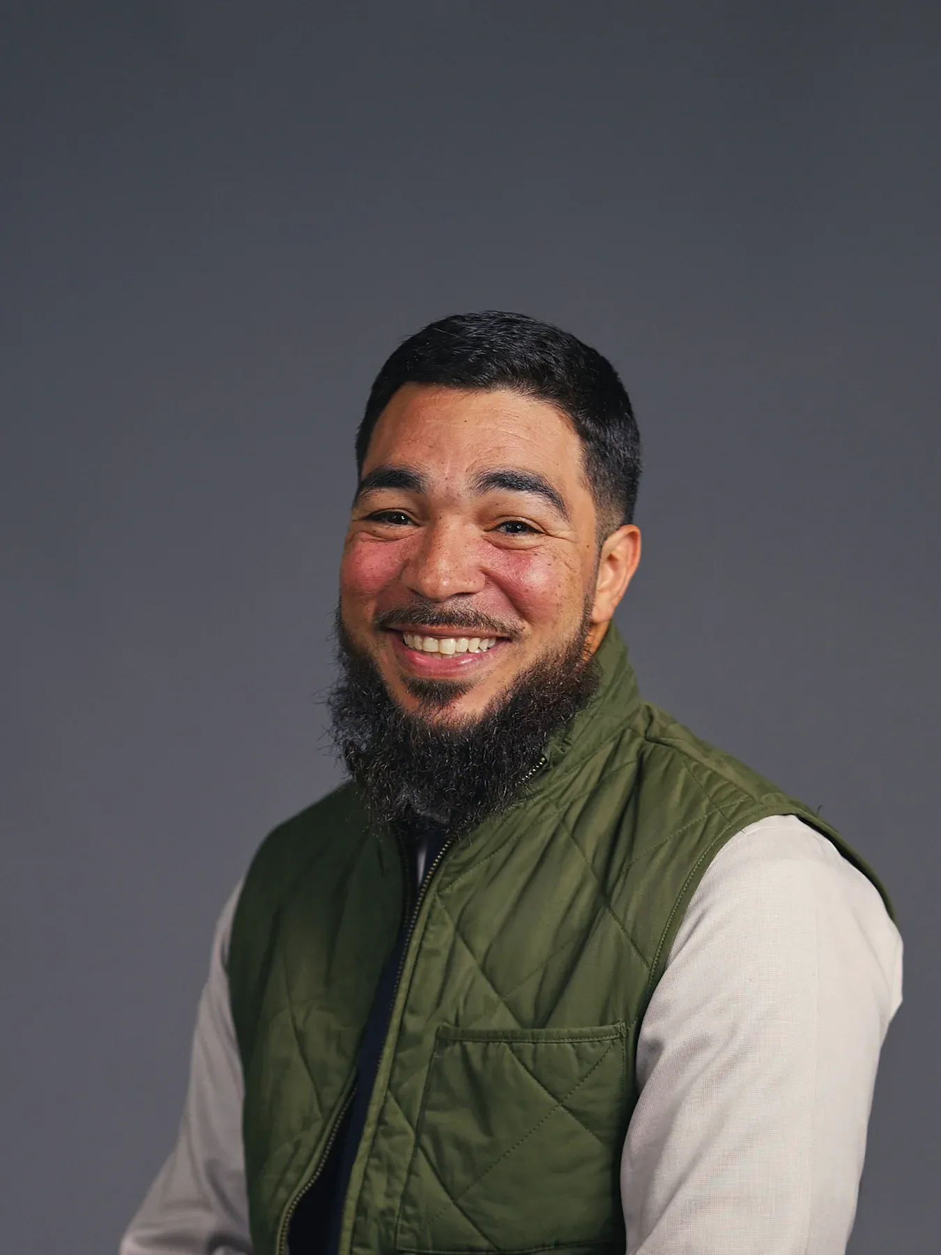 Bayaan Academy staff member smiling for a yearbook portrait