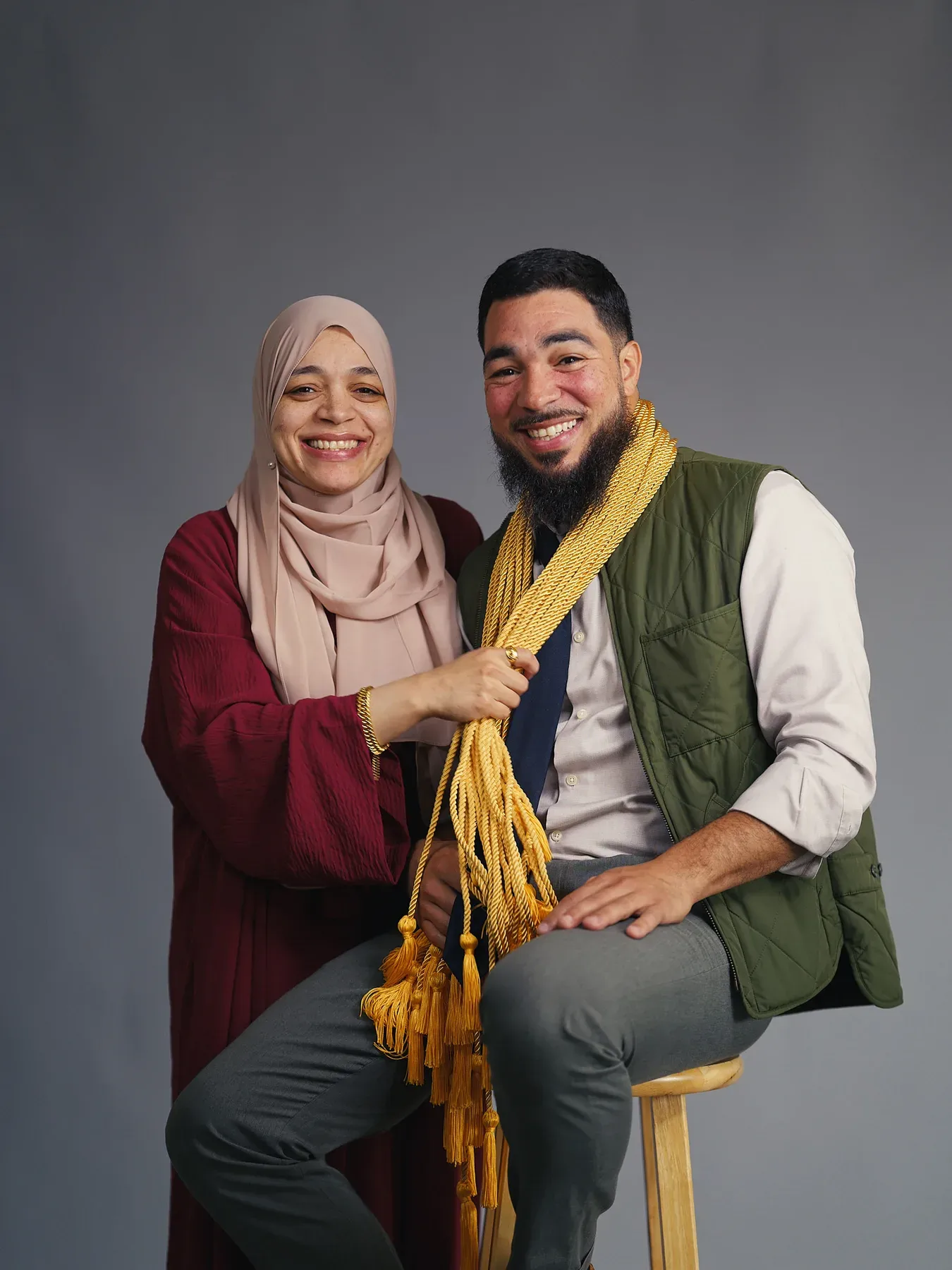 Two Bayaan Academy staff members posing together with graduation cords