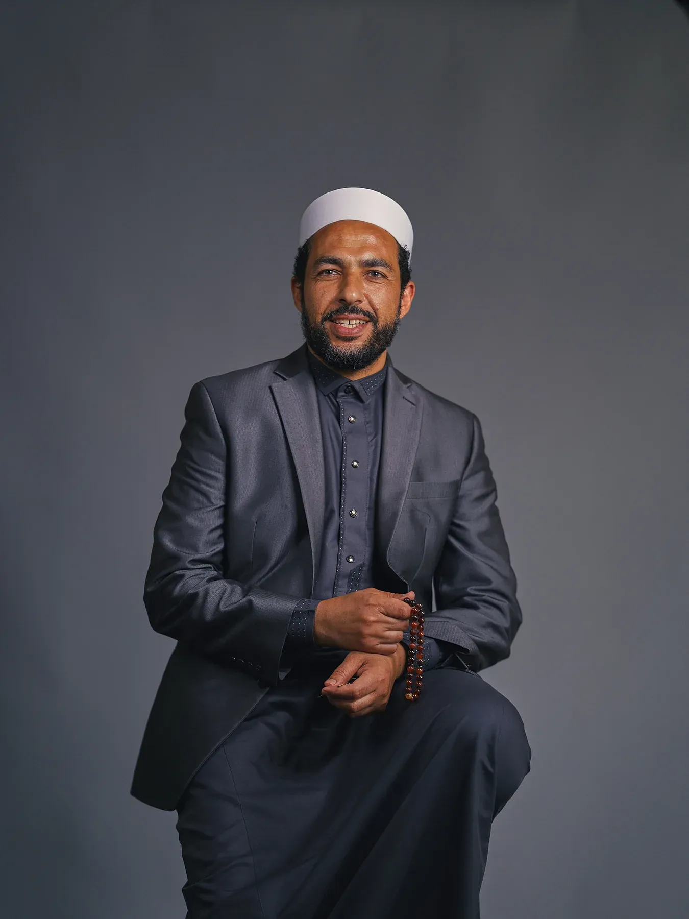 Bayaan Academy staff member wearing a dark suit for a portrait